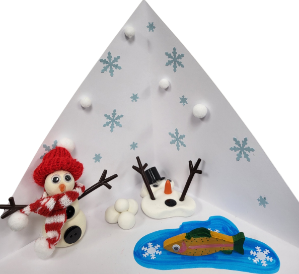 A clay snowman with a scarf and hat next to a melted snowman and a trout.