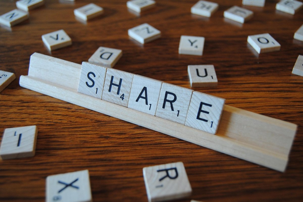 Word game pieces that spell "SHARE"