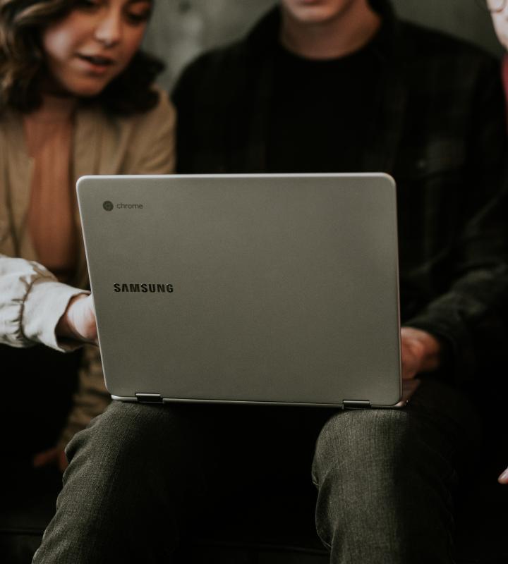 People looking at laptop screen