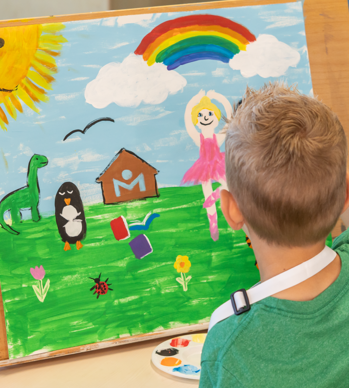 Young child painting.